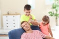 Children painting their father`s face while he sleeping Royalty Free Stock Photo