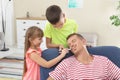 Children painting their father`s face while he sleeping Royalty Free Stock Photo