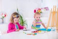 Children paiting on wooden easel Royalty Free Stock Photo