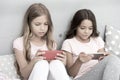 Children in pajama interact with smartphones. Application for kids fun. Internet surfing and absence parental advisory