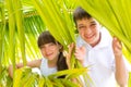 Children in palm branches Royalty Free Stock Photo