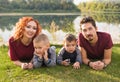 Children, parenthood and nature concept - Big family lying on the grass Royalty Free Stock Photo