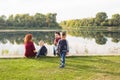 Children, parenthood and nature concept - Big family sitting on the grass Royalty Free Stock Photo