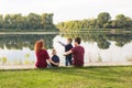 Children, parenthood and nature concept - Big family sitting on the grass Royalty Free Stock Photo