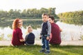 Children, parenthood and nature concept - Big family sitting on the grass Royalty Free Stock Photo