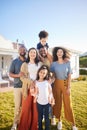 Children, parents and grandparents at house outdoor to relax for summer vacation. Men, women and kids or interracial Royalty Free Stock Photo