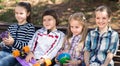 Ordinary children in the park on a bench in autumn Royalty Free Stock Photo