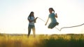 children in the park playing rope jumping. happy family kid dream concept. little girl jumping over a big jump rope Royalty Free Stock Photo