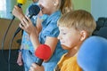 Children participate with a microphone, recite poems, recitation