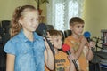 Children participate with a microphone, recite poems, recitation