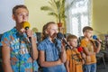 Children participate with a microphone, recite poems, recitation