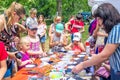 Children participating at art and craft outdoors workshop, making funny paper faces