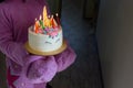 Children party entertainer gives tasty bright cake decorated in form of fantasy unicorn for kid celebrating birthday with friends