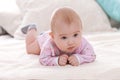 Portrait of cute baby girl lying on the bed at home. Royalty Free Stock Photo