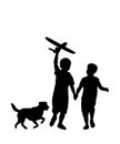 Children and pets silhouettes. Little boys play with a toy airplane and a dog. Royalty Free Stock Photo