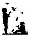 Children and pets silhouettes. Little girl and boy play and feed birds.