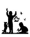 Children and pets silhouettes. Little girl and boy play and feed birds.