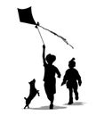 Children and pets silhouettes. Little girl and boy play with a kite and a dog. Royalty Free Stock Photo