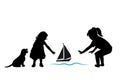 Children and pets silhouettes. Little girls play with a toy ship and a dog. Royalty Free Stock Photo
