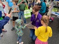 Children Petting a Lizard at the Neighborhood Festival in July