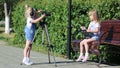 Children with photo appart in a city park.