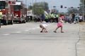 Children pickup candy in a parade in small town America