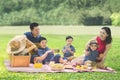 Children picnicking with their parents in the park