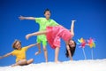 Children with pinwheels on beach