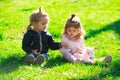 Children on pirnic. Cute boy and girl sit on grass on summer field. Happy baby children playing on green grass in spring Royalty Free Stock Photo