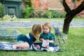 Children on pirnic. Cute kids love. Little girl kissing little boy outdoors in park. Cute little baby on the meadow Royalty Free Stock Photo