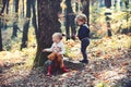 Children play in autumn forest. Little boy and girl friends camping in woods. Brother and sister have fun on fresh air Royalty Free Stock Photo