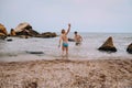 Children play beach sea stones fun activity Royalty Free Stock Photo