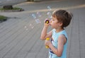 The boy blows soap bubbles. Royalty Free Stock Photo