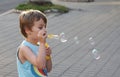 The boy blows soap bubbles. Royalty Free Stock Photo