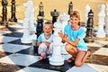 Children play chess outdoor. Royalty Free Stock Photo
