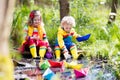 Kids playing with colorful paper boats in a park Royalty Free Stock Photo