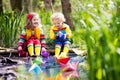 Kids playing with colorful paper boats in a park Royalty Free Stock Photo