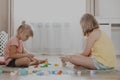 Children playing with toy building blocks on the floor at home or kindergarten Royalty Free Stock Photo