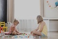 Children playing with toy building blocks on the floor at home or kindergarten Royalty Free Stock Photo