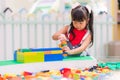 Children play with colorful plastic toys blocks on table Royalty Free Stock Photo