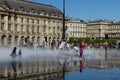 Children play and enjoy on the Water Mirror in the Place de la Bourse. Bordeaux.