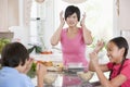 Children Play Fight While Having Breakfast Royalty Free Stock Photo