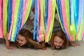 Children play a game crawl under the tape