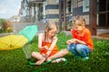 Children playing with garden sprinkler. Brother and sister running and jumping. Summer outdoor water fun in backyard