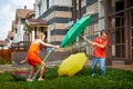 Children playing with garden sprinkler. Brother and sister running and jumping. Summer outdoor water fun in backyard