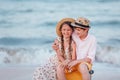 Children play and have fun on the beach. The girl and the guy run away from the wavesThe girl and the boy are sitting on a yellow Royalty Free Stock Photo