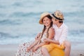 Children play and have fun on the beach. The girl and the guy run away from the wavesThe girl and the boy are sitting on a yellow Royalty Free Stock Photo