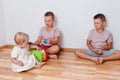 Children play at home. three children sit on the floor