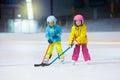 Children play ice hockey. Kids winter sport.