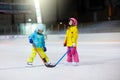 Children play ice hockey. Kids winter sport Royalty Free Stock Photo